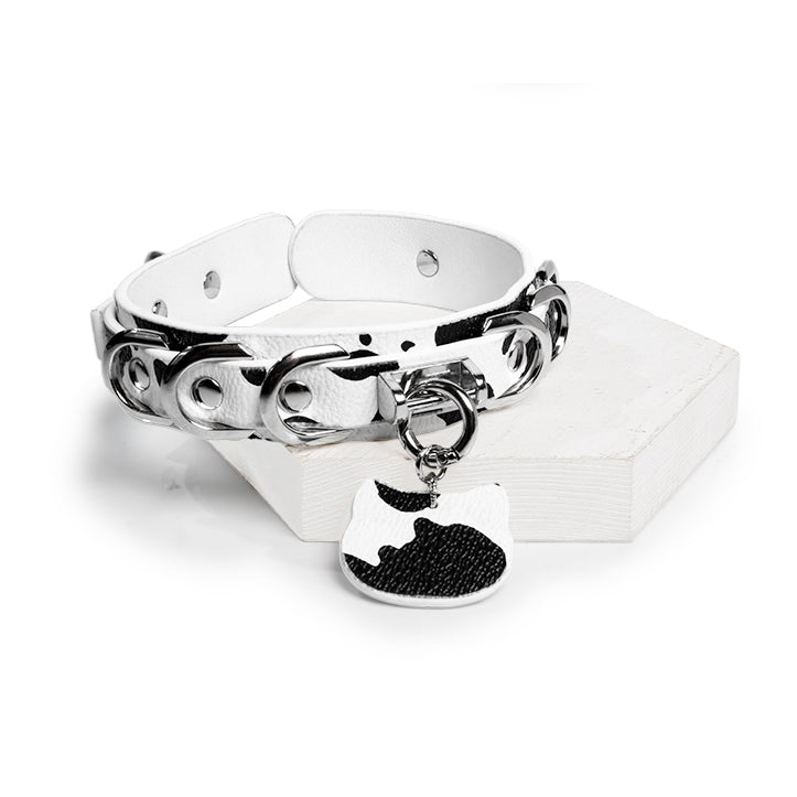 WILDCHOK Black‑White Cow Print O‑Ring Choker | Adjustable PU Leather Necklace with Cat‑Head Charm