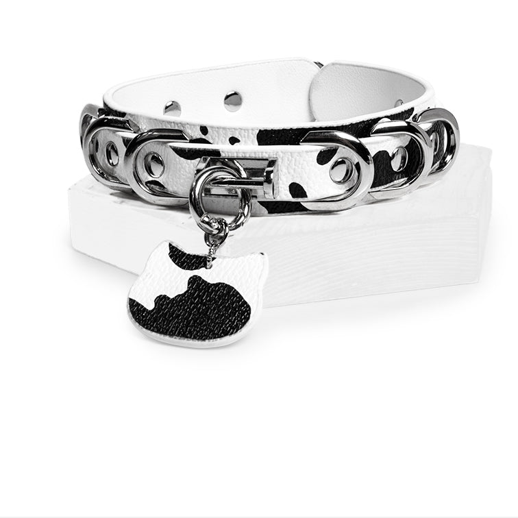 WILDCHOK Black‑White Cow Print O‑Ring Choker | Adjustable PU Leather Necklace with Cat‑Head Charm