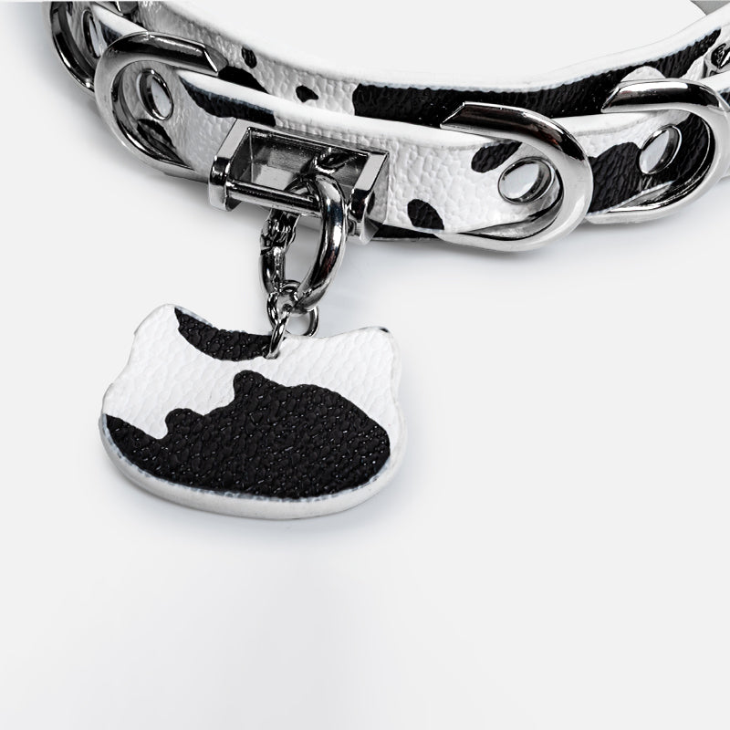 WILDCHOK Black‑White Cow Print O‑Ring Choker | Adjustable PU Leather Necklace with Cat‑Head Charm